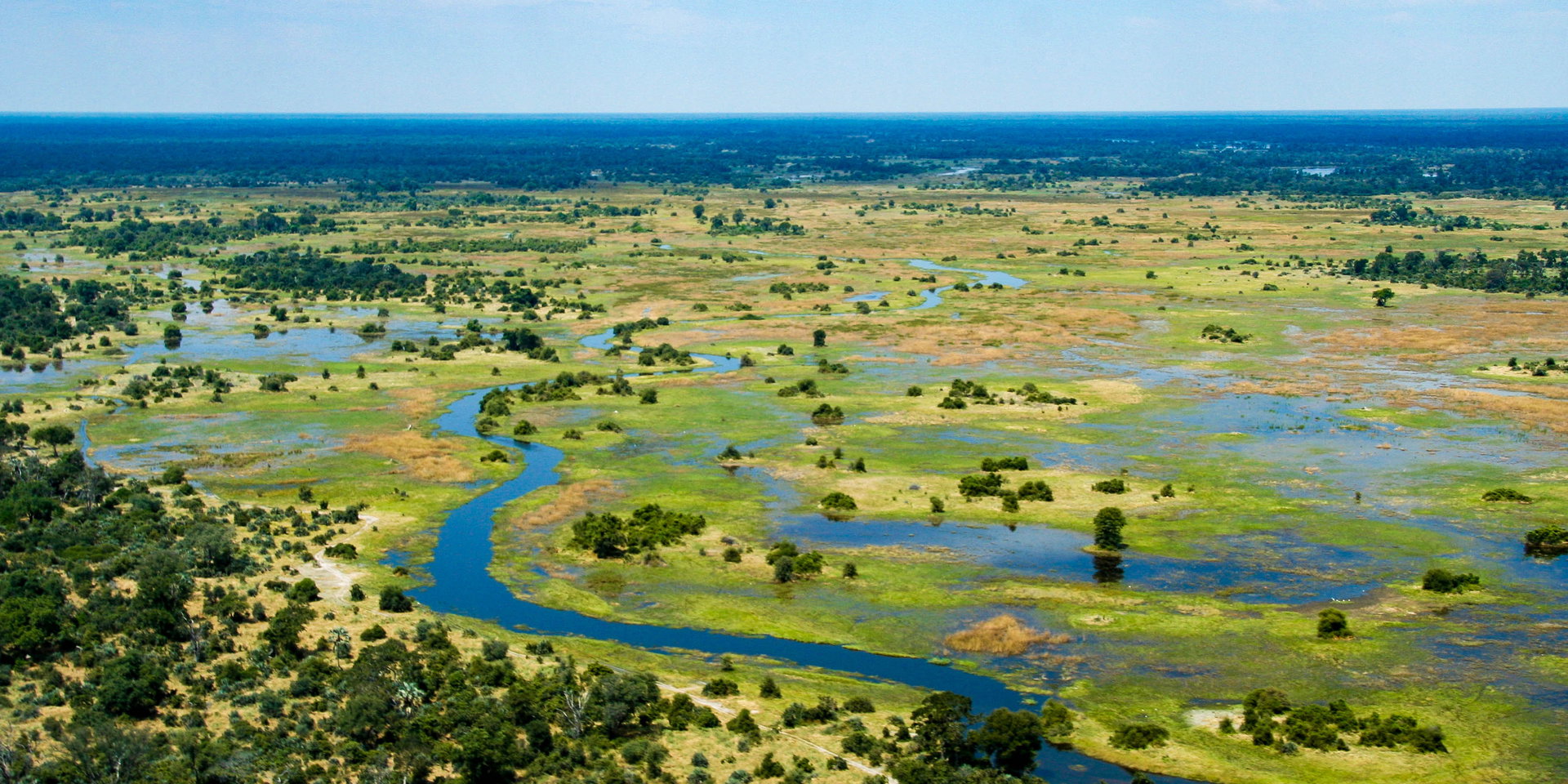 Aerial view of winding channels, islands and floodplains stretching to the horizon.