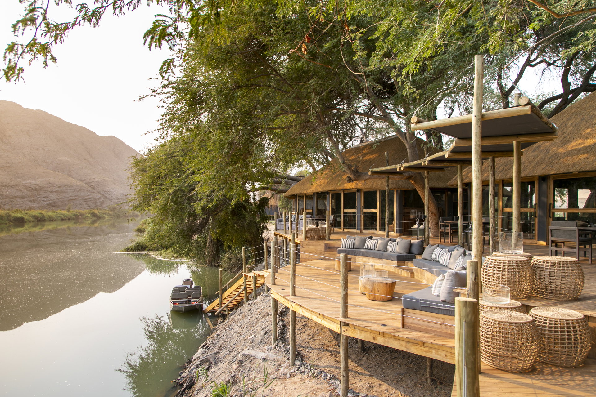 The decks of Serra Cafema under the trees on the bank of the Kunene River
