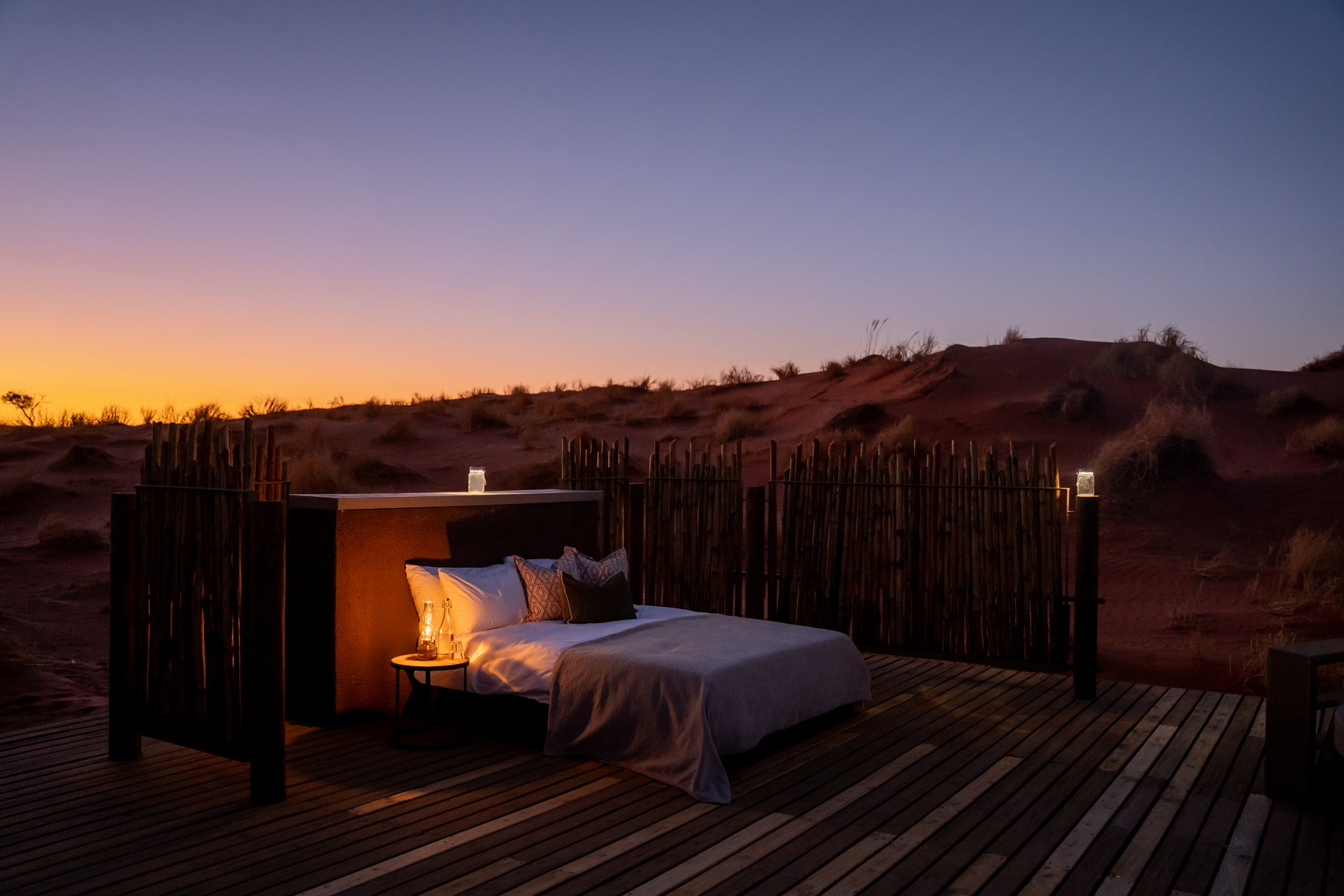 A Starbed made up on a deck at Wolwedans Dune Camp at dusk