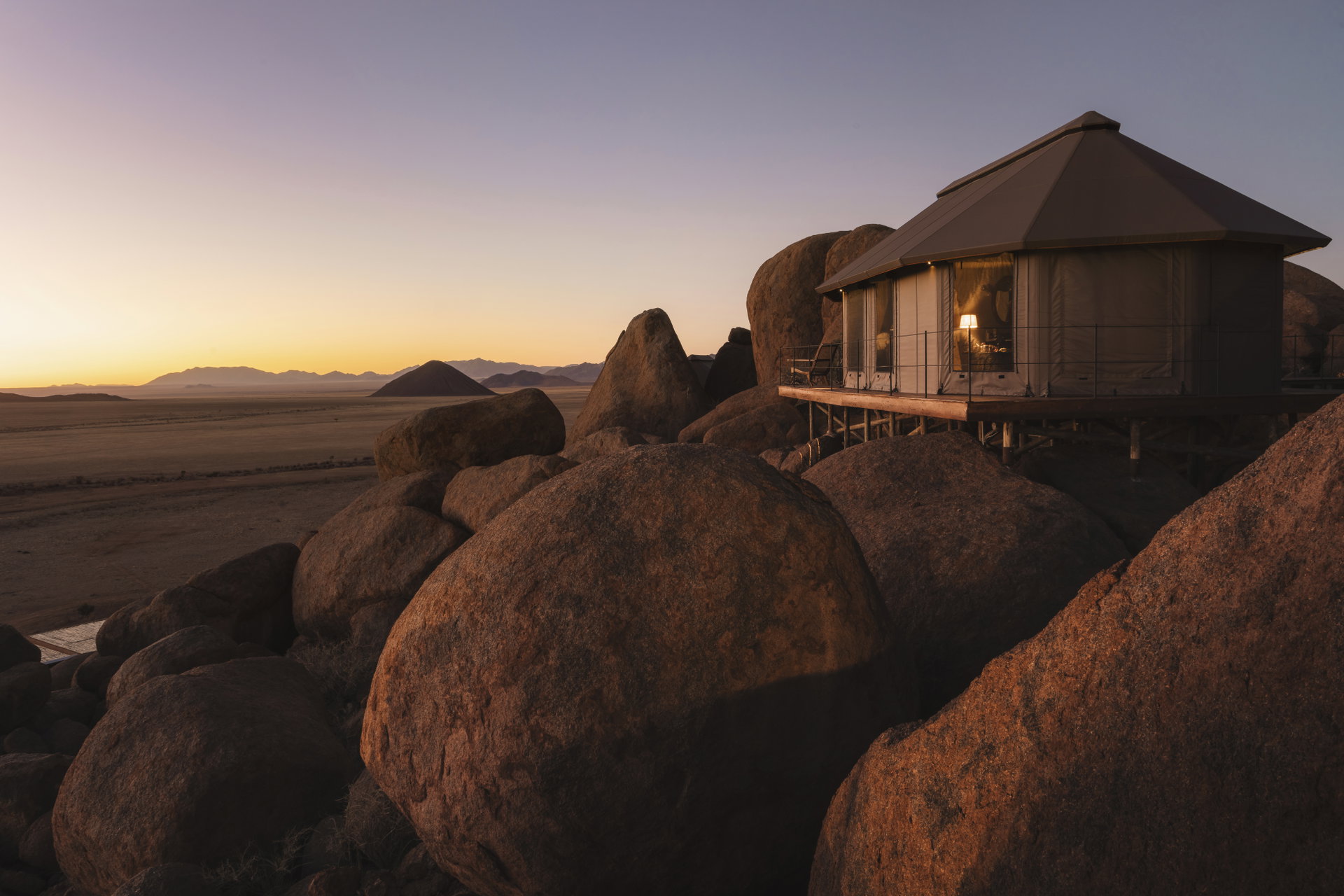 A tent of Zannier Sonop on top of the granite boulders at dusk