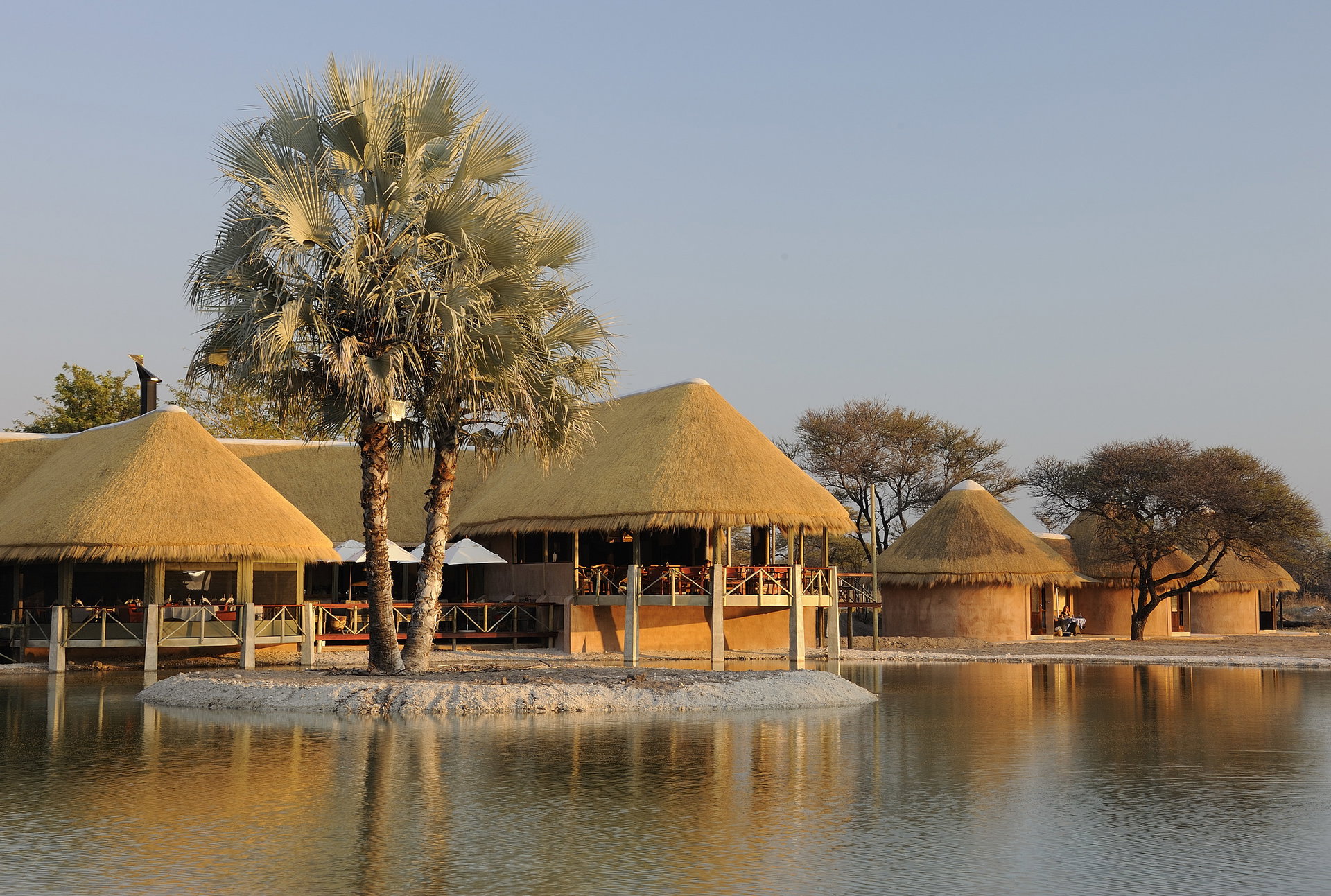 Onguma Bush Camp reflected in its waterhole