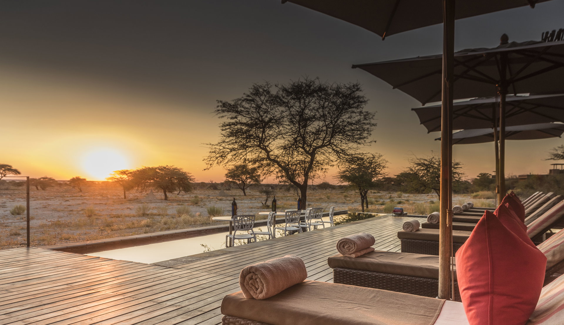 The sun setting over the bush from a deck at Onguma