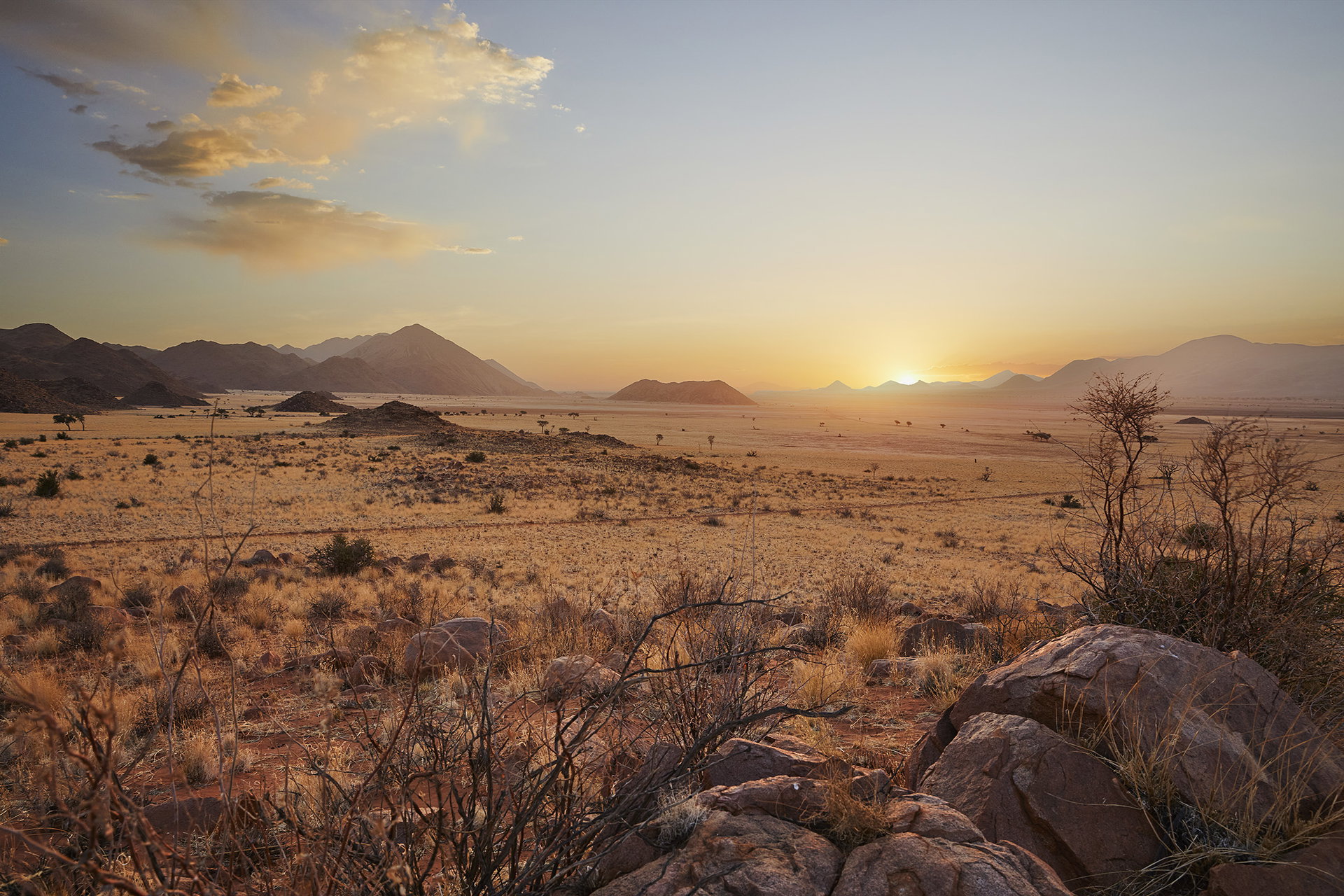 The sun setting over the hills and grassland of the Sinclair Nature Reserve
