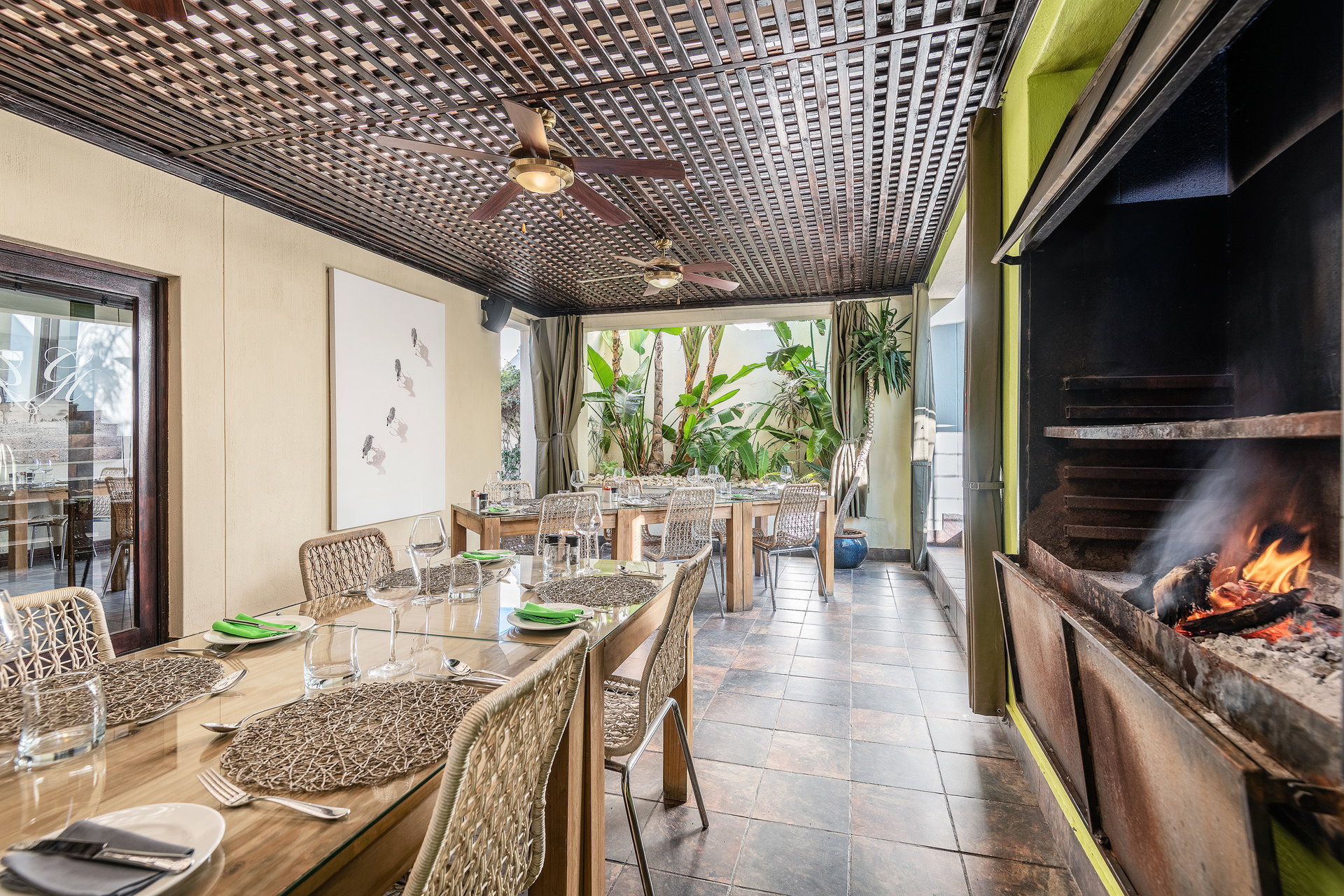 The dining room at Galton House with a fire burning in the braai