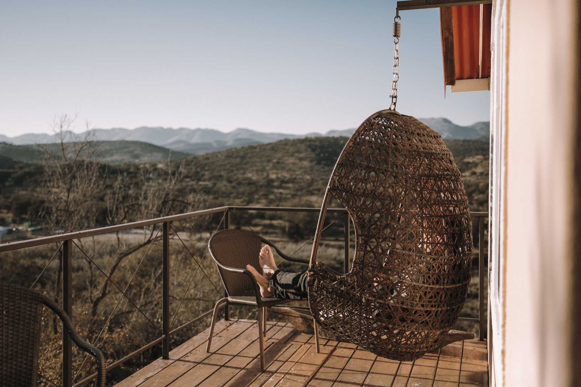A hanging chair on a balcony at Ti Melen looking out over the hills