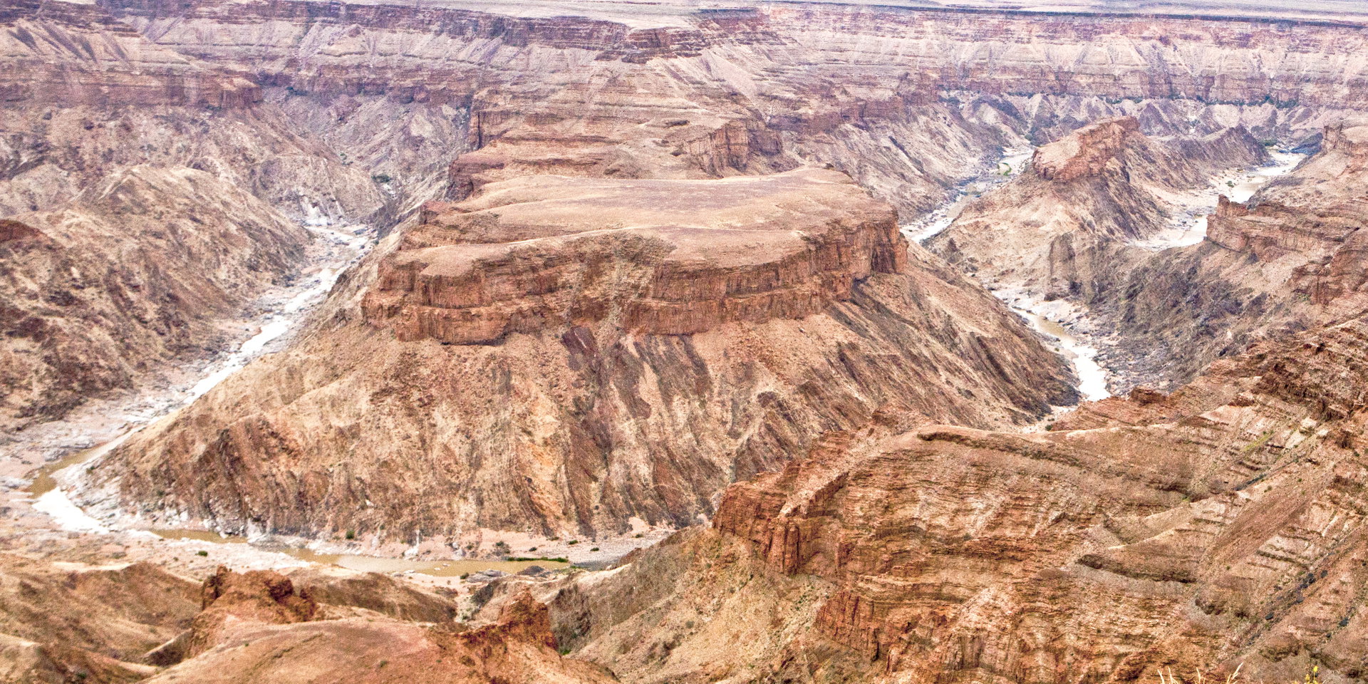 Aerial view of the deep, winding Fish River Canyon with the river at its floor.