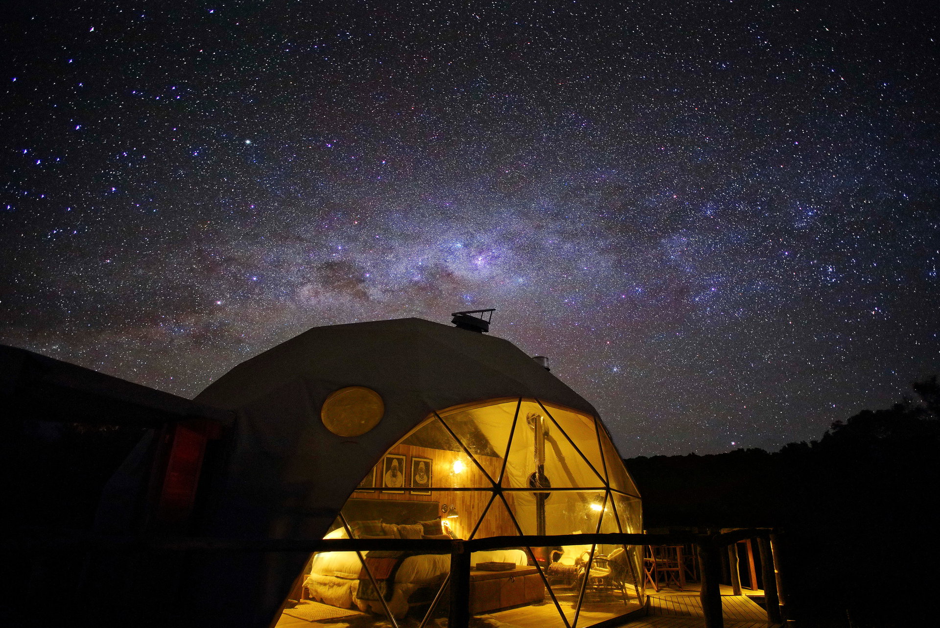 A dome at The Highlands glowing under the night sky