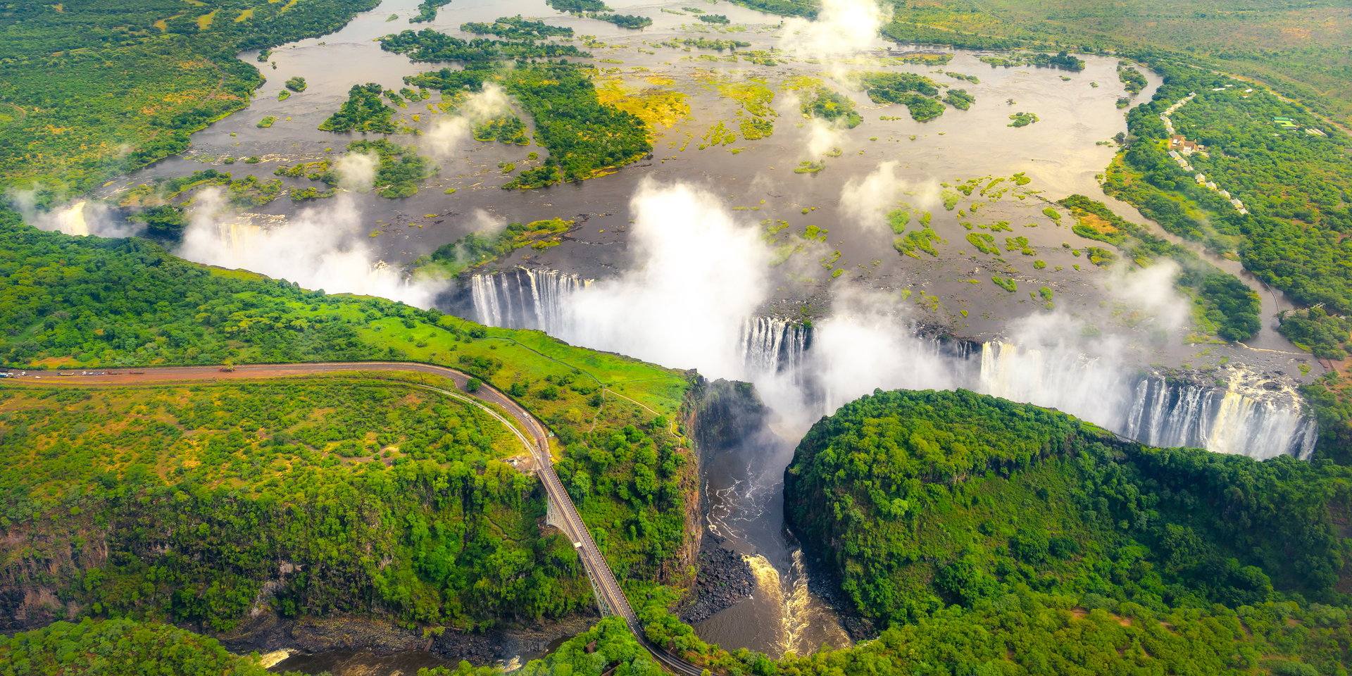 Aerial view of the falls, spray rising from the zigzag gorges below.
